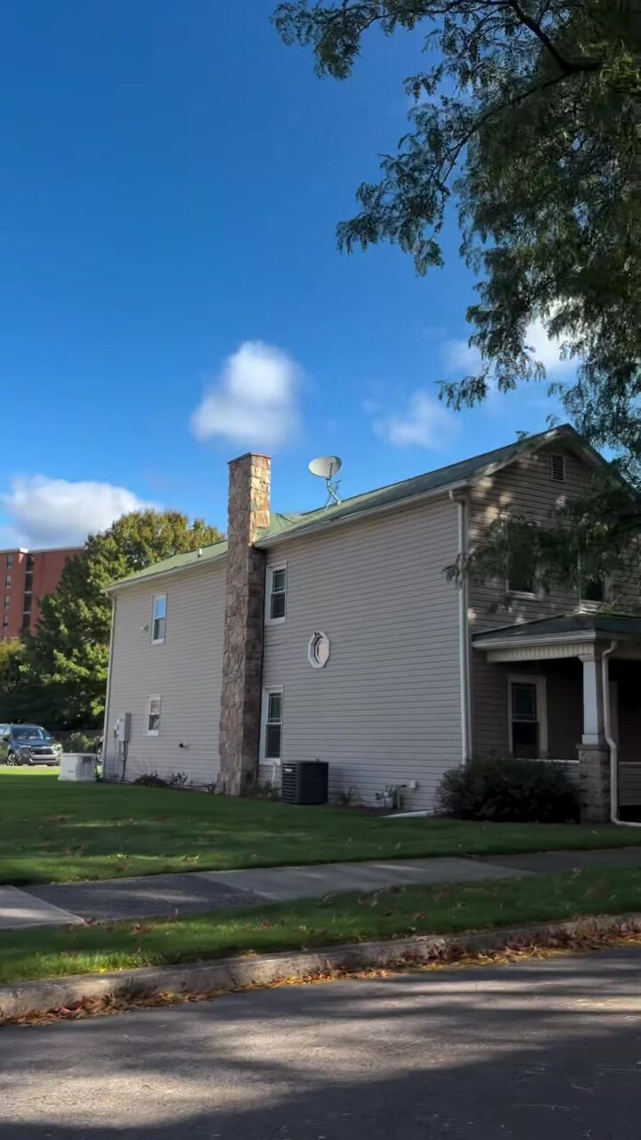 Two-story home on W Edwin St with a stone chimney