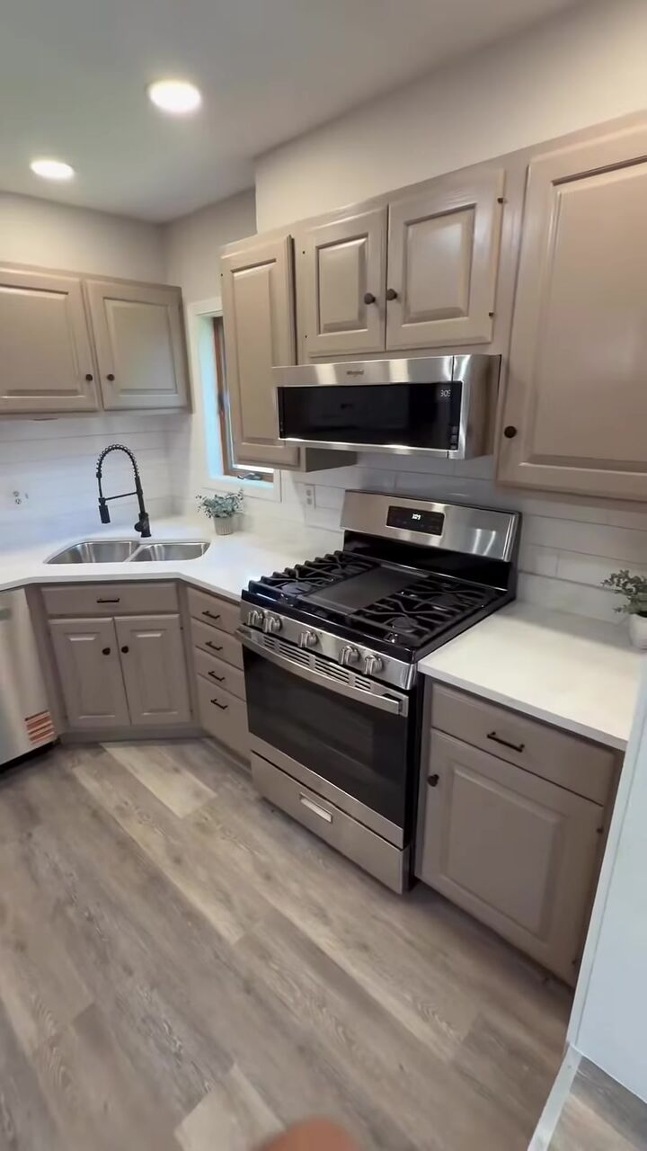 Updated kitchen with gray cabinets and stainless appliances