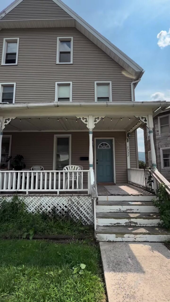 Two-story duplex with a white front porch